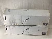 Two white cardboard boxes with James Loudspeaker branding, marked fragile.