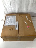 Sealed brown shipping box with handwritten Mod.4 Loudspeaker Amp on label