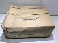 Closed cardboard box labeled James Loudspeaker Model Four subwoofer amplifier.