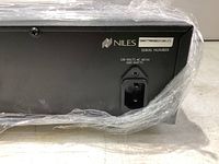 Rear panel of the amplifier showing power input socket, brand logo, serial number, and voltage/wattage rating.