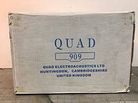 Front of cardboard box with ‘QUAD 909’ branding and manufacturer info