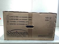 Front of sealed Sherbourn cardboard box, model list with checkbox marked next to '7/2100 A (7 CHANNEL AMP)' and '120V'