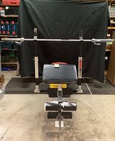 Full front view of assembled Weider Pro 800 bench with Olympic barbell loaded on uprights