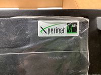 Close-up of the Xperinet MIRV logo on the server unit inside plastic wrap.