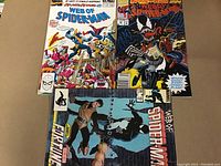 Top view of three Spider-Man comics showing cover art, including Web of Spider-Man Annual, Web of Spider-Man #25, and another Spider-Man comic with Venom