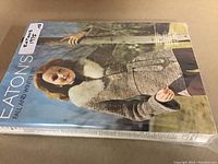 Cover photo of Eaton's 1975 Fall and Winter catalog showing a woman in a fur-trimmed coat outdoors.