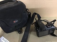 FujiCo FinePix S digital camera with case and strap displayed on a beige surface.