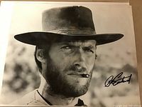 Close-up of the 8x10 black and white photo showing Clint Eastwood in a cowboy hat with a cigar and signature on lower right.