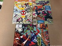 Three Spider-Man comics laid flat showing front covers. Two 'Web of Spider-Man' issues clearly visible with title and cover characters.
