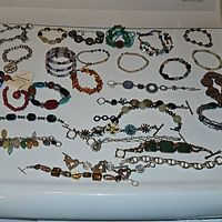 Full assortment of bracelets laid out showing variety of styles, bead types, and sizes