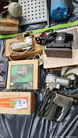 Photo showing multiple power tools including jig saws, a palm sander, and boxed saber saw.