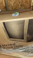 Photo of the sealed cardboard box of Macintosh Portrait Display showing front with text and partial apple logo