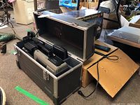 Panasonic AG-450 camcorder and accessories in protective hard case, alongside Cam Quip video transfer box.