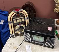 Crosley CR-711 radio and GE retro jukebox radio together showing front and side views on a table