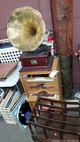Victrola and record cabinet with magazine rack in foreground