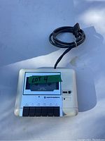 Top front view of Commodore cassette player/recorder showing control buttons and cable.