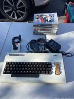 Overview: VIC-20 unit, joystick, power supply, RF switch and stacked game cartridges
