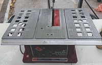 Full front view of the Delta 10-inch bench saw showing table surface, blade slot, and measurement markings.