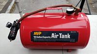 Side view of red MVP 10 gallon air tank showing brand label and hose with valve handle.