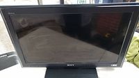 Front view of black Sony 32 inch LCD TV showing screen and Sony logo on bezel.