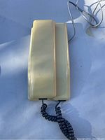 Top view of the cream/beige plastic handset showing no visible damage.