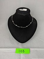 Front view of the 925 silver necklace with multicolor freshwater pearls displayed on a black jewelry stand.