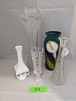 Lot of five vases showing overall assortment including hand painted calla lily vase and clear crystal vases.