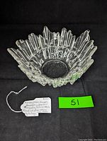 Front angle of clear ice glass bowl with jagged edges and textured surface.