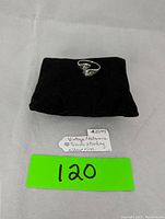 Photo of vintage nielloware sterling silver ring on black cushion with handwritten label.