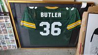 Front view of wood framed Green Bay Packers #36 Butler jersey