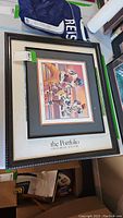 Framed football art print showing a baseball stadium scene and signed football player figures
