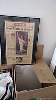 Framed newspaper front page featuring golfer celebrating