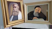View of both framed paintings showing elderly Jewish men with beards, one oil on canvas and gold frame, one oil on board and light frame.