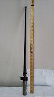 Full length photo showing bayonet next to measuring ruler.
