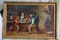 Frontal view of vintage oil painting on canvas featuring card players in a rustic indoor setting, with ornate gold frame.
