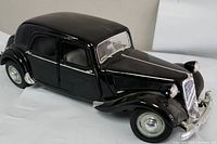 Front and side view of the black Maisto Citroen 150V 1:18 scale model car showing details on body, wheels and grille.