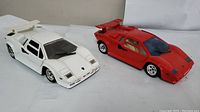 Two diecast Lamborghini Countach 5000 models brand Majorette in white and red, side view