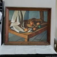 Frontal view of the framed oil painting showing the entire still life composition with table, cloth, onions, and background frame.