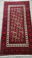 Top view of rectangular wool wool Persian vintage rug with geometric medallion patterns and borders in red, white, and black.