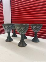 Set of five handcrafted pottery wine goblets with green and black glaze and textured design