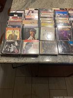 Overview of multiple jazz and classical CDs stacked on a table showing various artists and album covers.