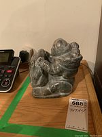 Front angle showing full sculpture on wooden surface