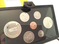 Photo shows the full coin set displayed in a protective black plastic holder, coins include 1 cent through 1 dollar, all appear uncirculated.