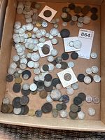 Wide view of tray containing various early coins scattered