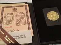 Coin in display case with certificate booklet visible