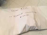 Handwritten envelope front showing 'Canada $0.50' and note about 17 coins totalling $110.50.