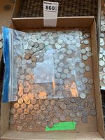 Box containing loose silver Canadian nickels and plastic bag with additional coins