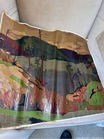 Full view of lithograph on canvas showing landscape of trees, rocks, lake and hills