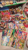 Overhead shot of comics, books and small toys spread on floor