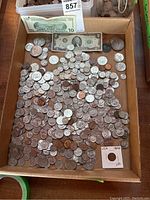 Overview of tray containing silver dollars, assorted coins, $10 and $2 bills